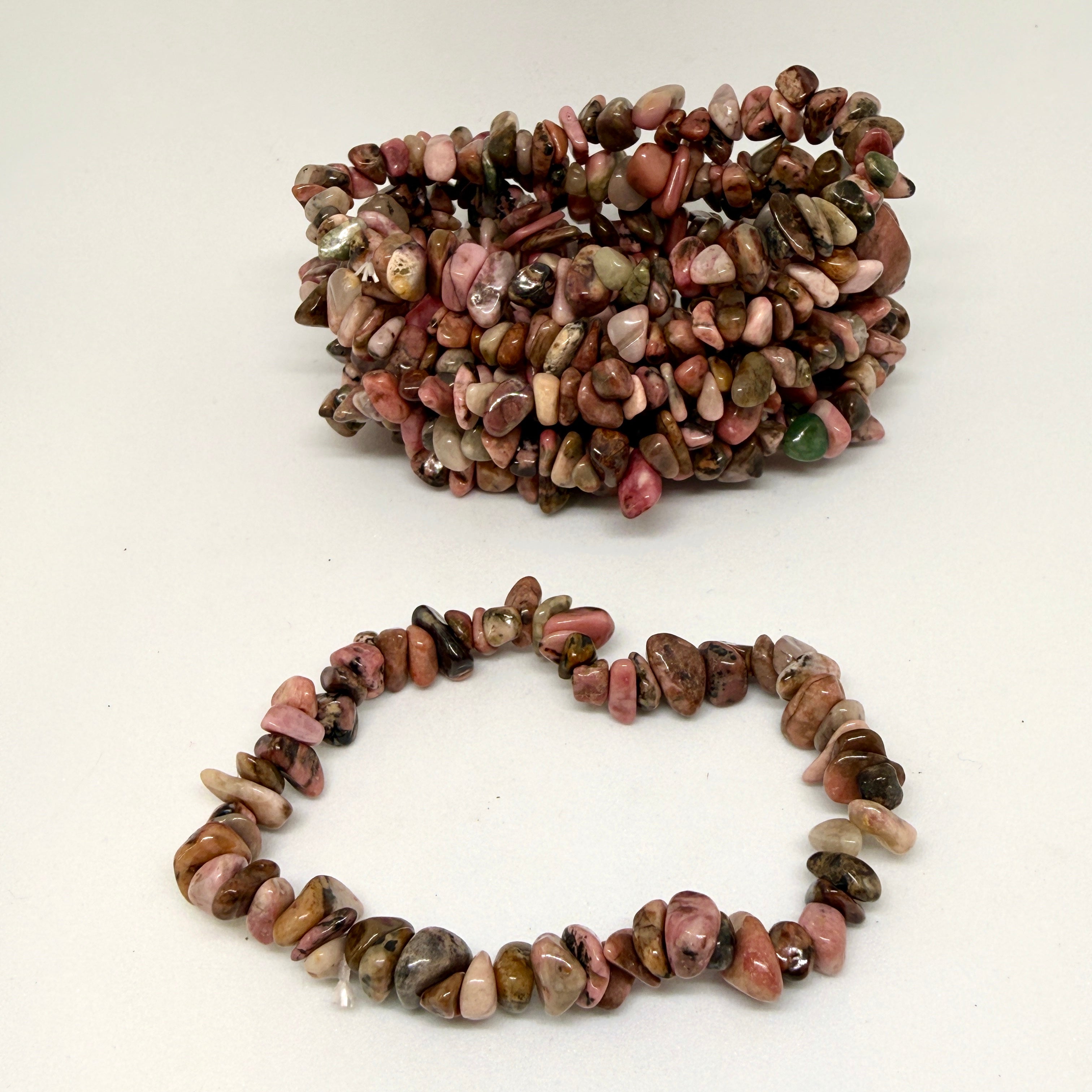 Bracelet made of multicolored stones on a white background