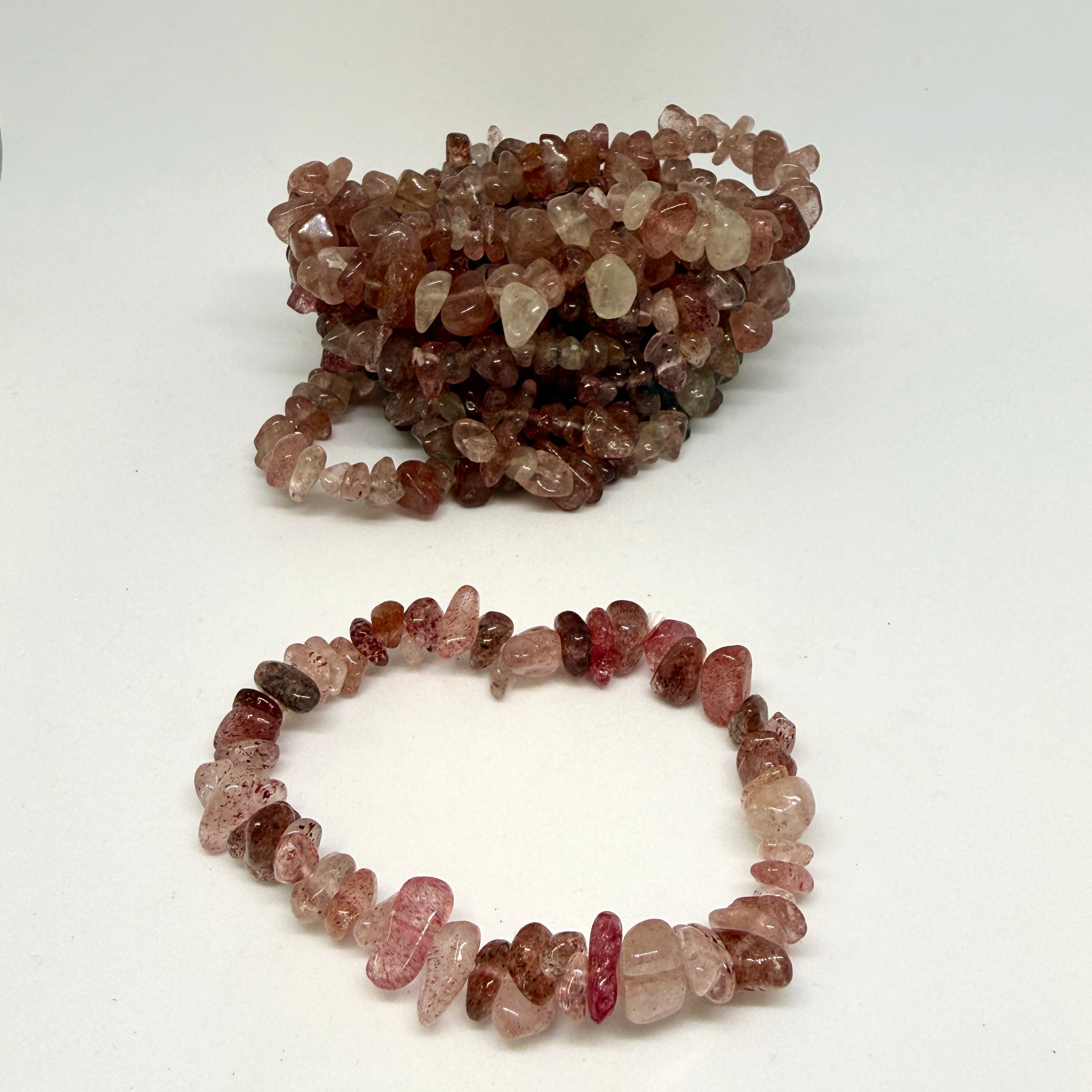 Two stone bead bracelets on a white background