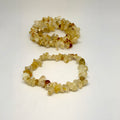 Two yellow stone chip bracelets on a white background
