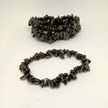 Two dark stone chip bracelets on a white background