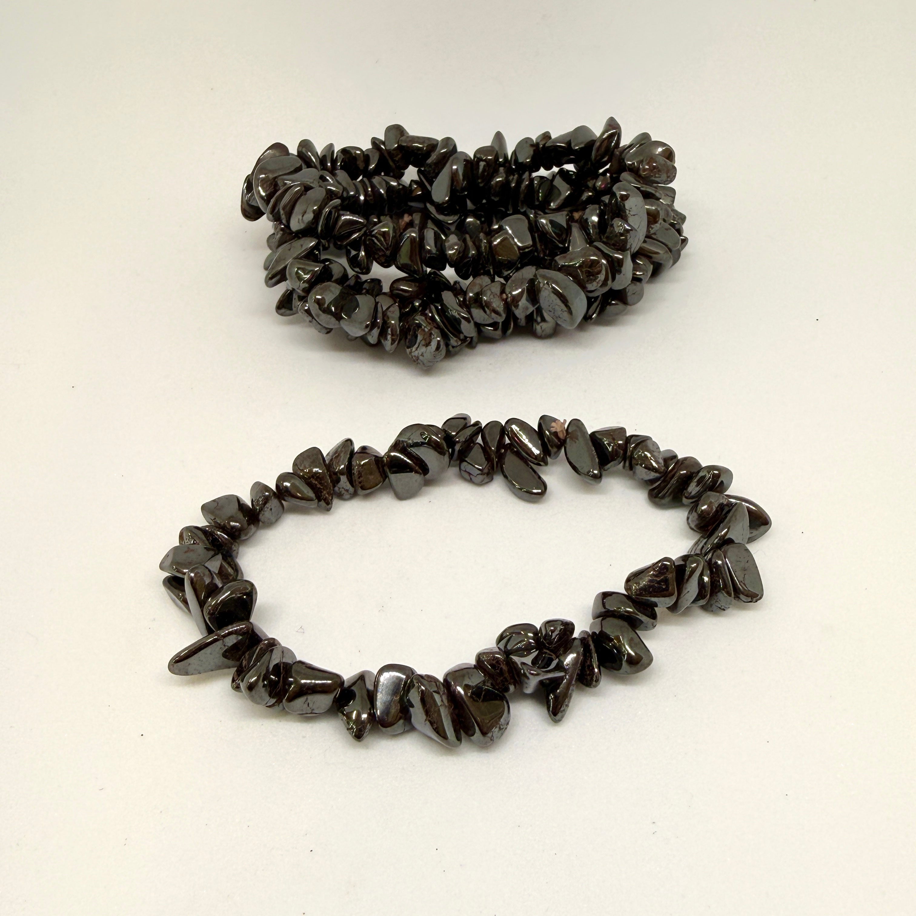Two dark stone chip bracelets on a white background