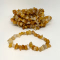 Bracelet made of small orange and white stones on a white background