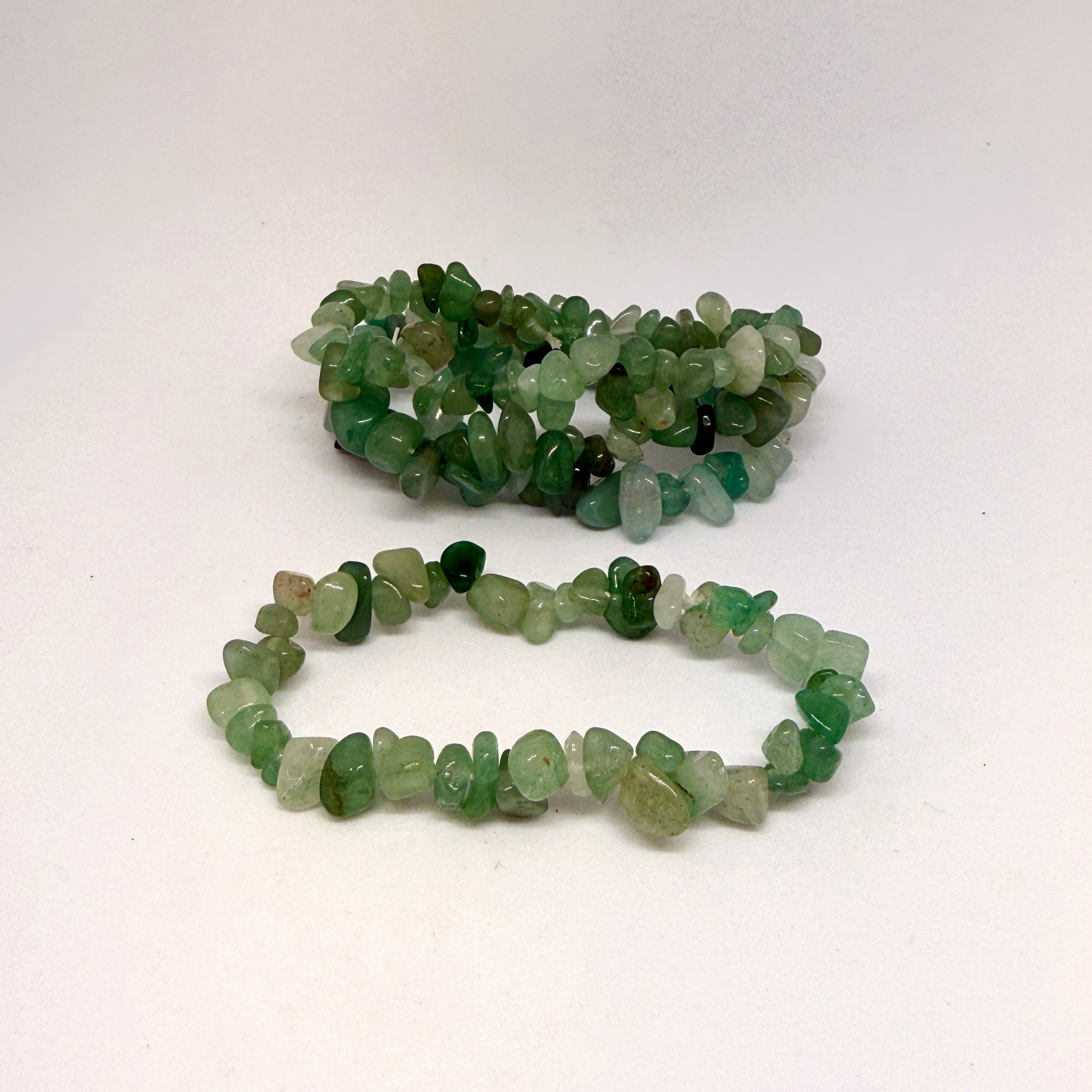 Two green bead bracelets on a white background