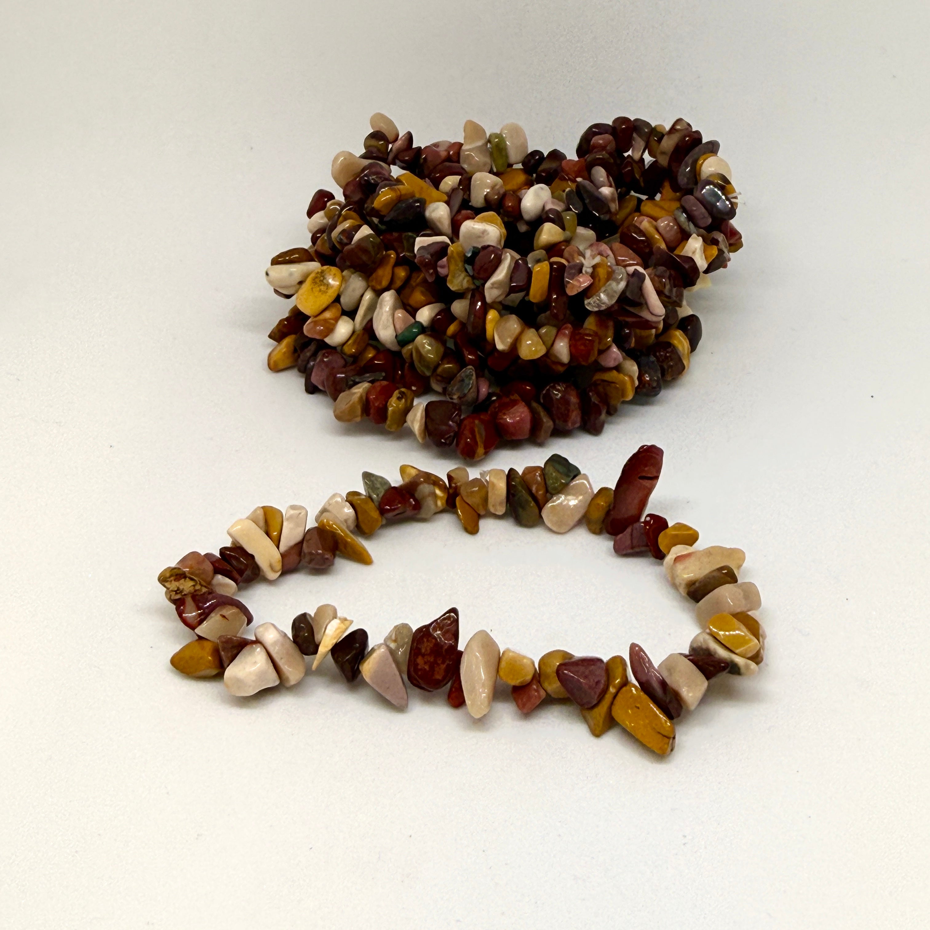 Bracelet made of multicolored stones on a white background