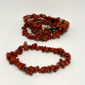 Two strands of brown stone beads on a white background