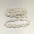 String of small white beads on a white background