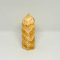 Yellow stone tower on a white background