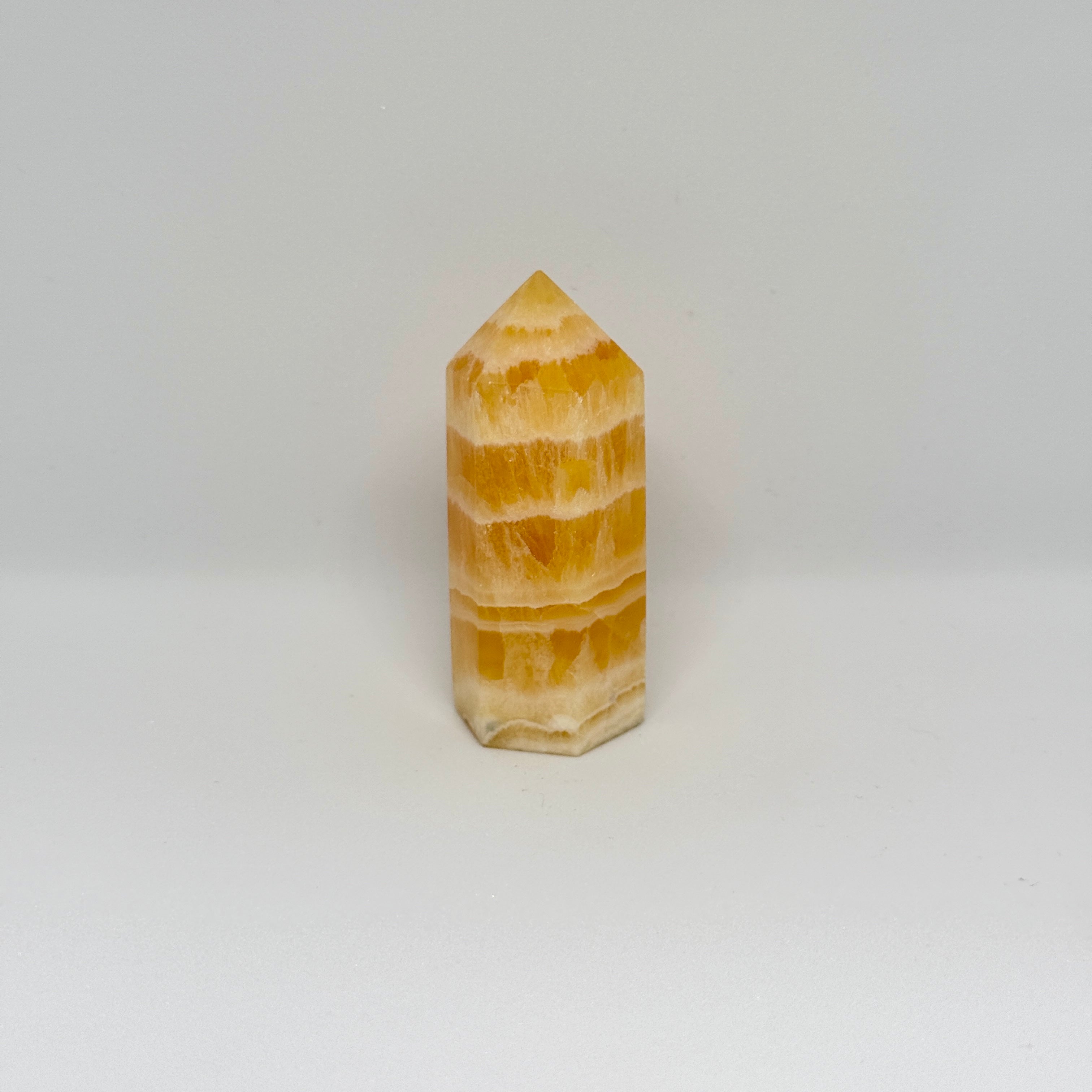 Yellow stone tower on a white background