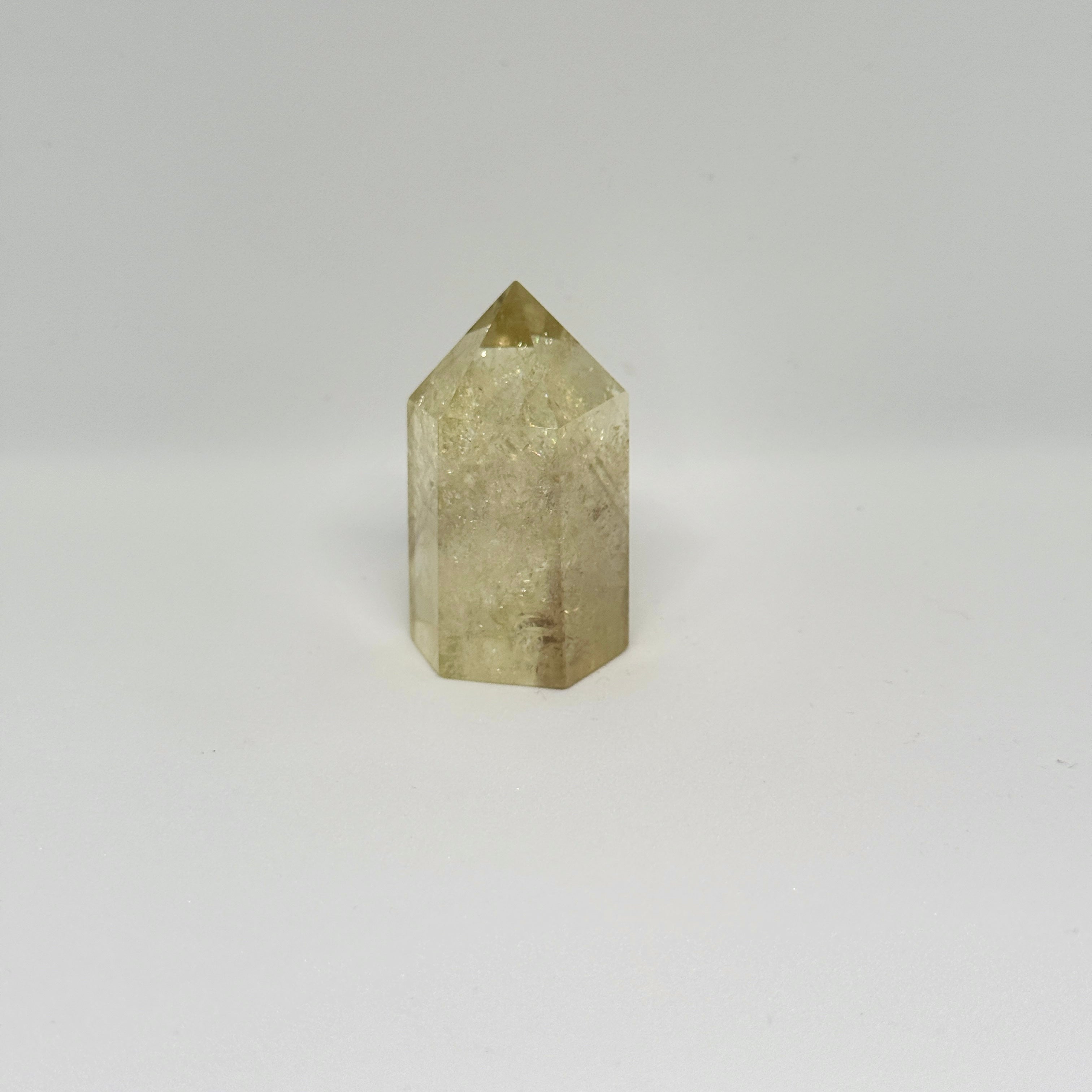 Hexagonal crystal prism on a light gray background