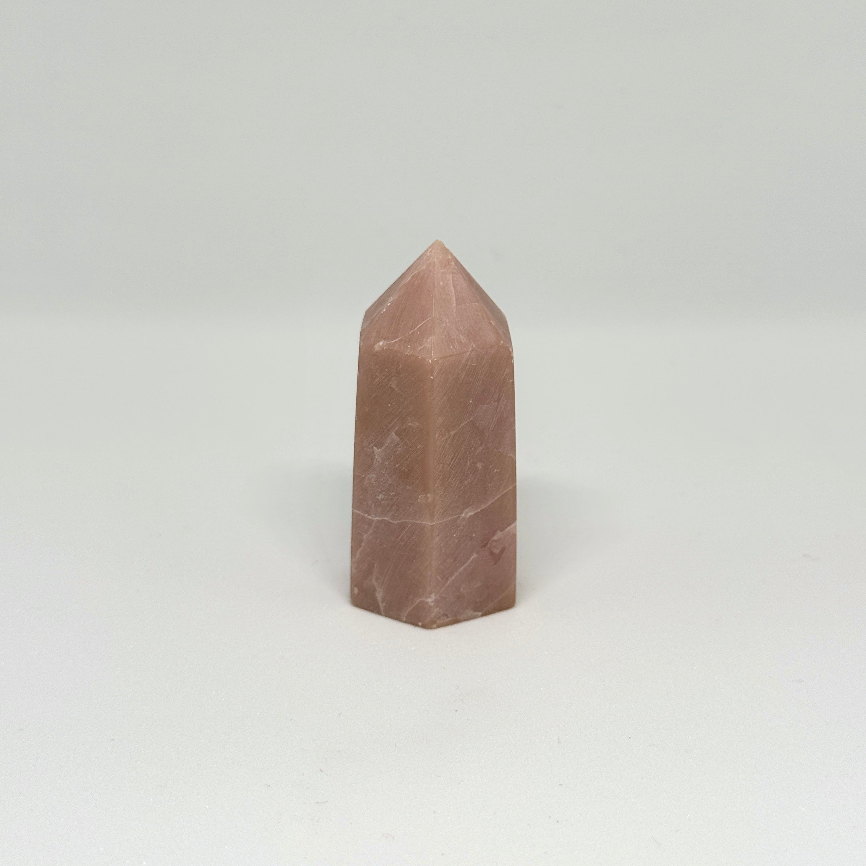 Brown crystal pyramid on a white background