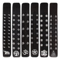 Set of black incense sticks with white symbols on a white background
