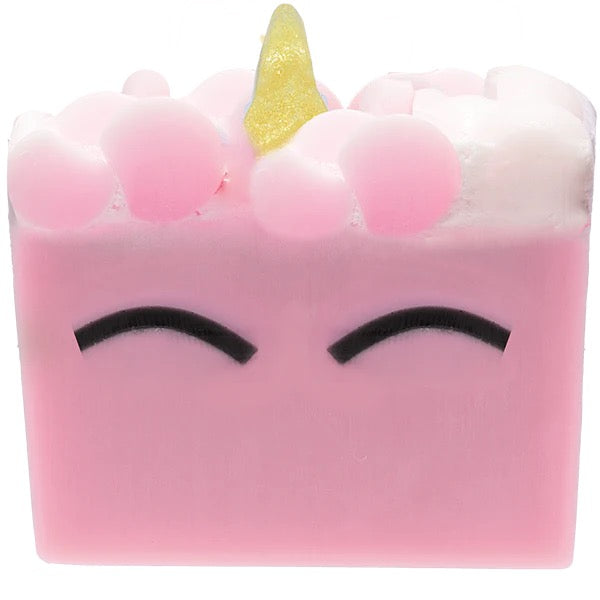 Pink soap bar with a yellow unicorn horn on a white background