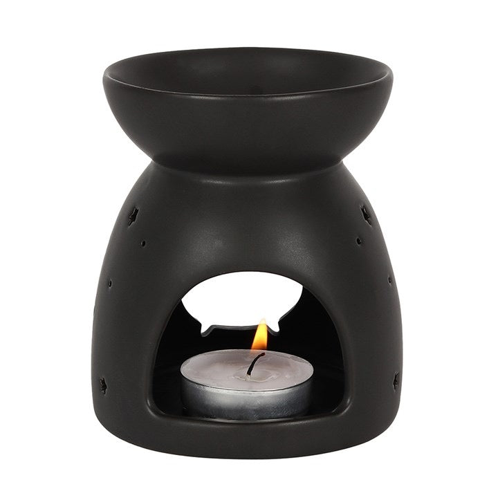 Black ceramic oil burner with a lit tealight candle on a white background