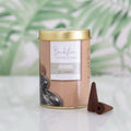 Incense cone container with a label on a light background