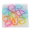 Colorful letter-shaped rubber bands on a white background