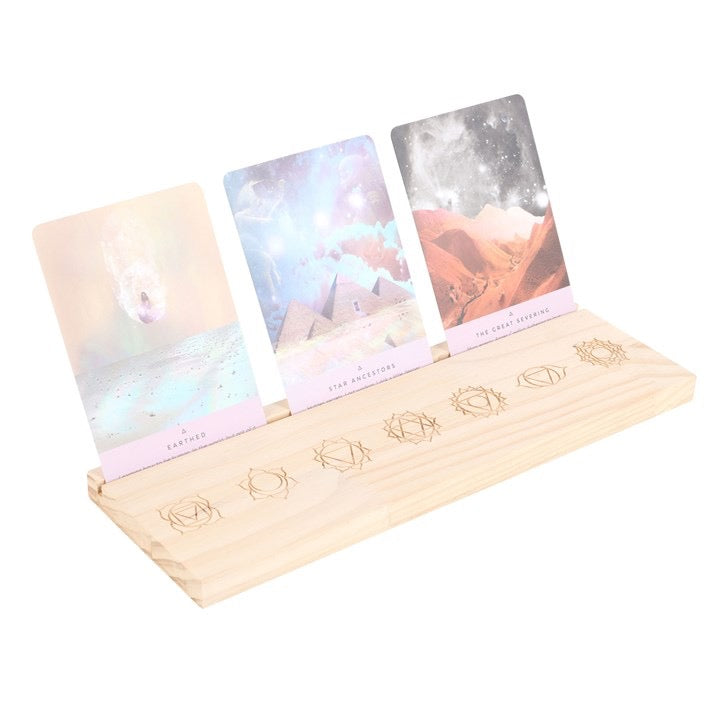 Set of tarot cards in a wooden holder on a white background