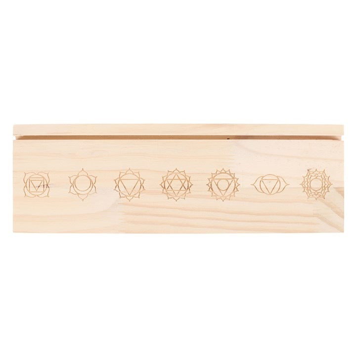 Wooden box with engraved symbols on a white background