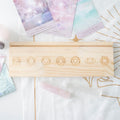 Wooden box with engraved symbols on a soft, patterned surface