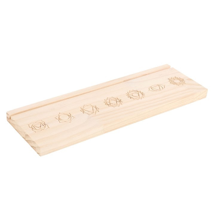 Wooden incense holder with engraved designs on a white background