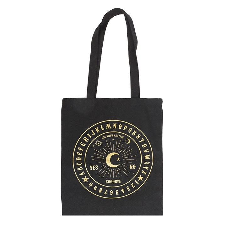 Black tote bag with gold Ouija board design on a white background