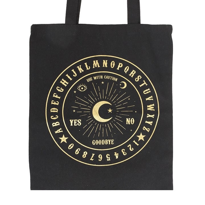 Black tote bag with gold Ouija board design on a white background