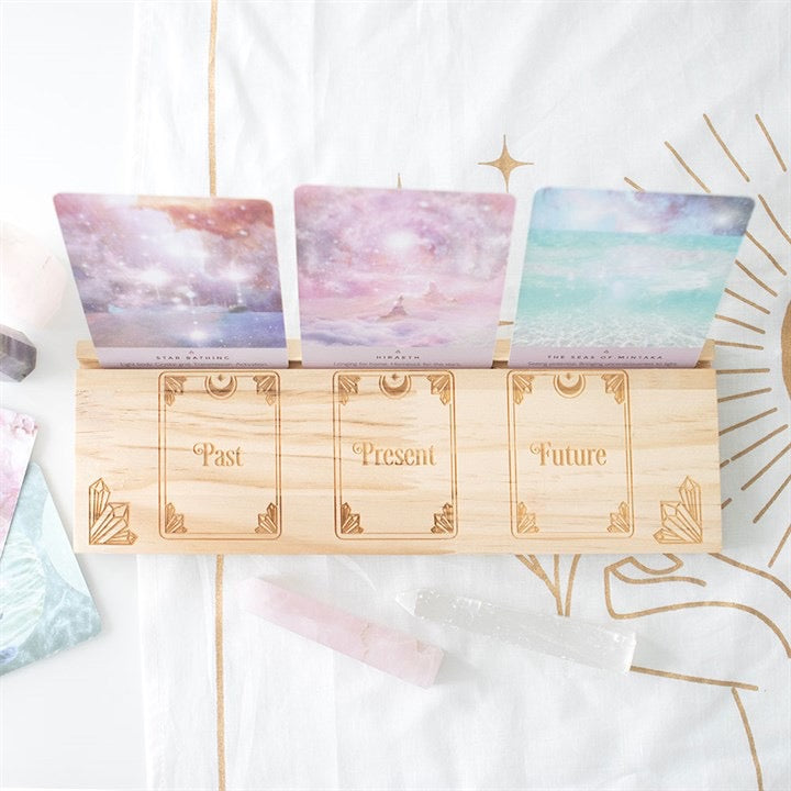 Set of tarot cards labeled 'Past', 'Present', and 'Future' on a decorative background.