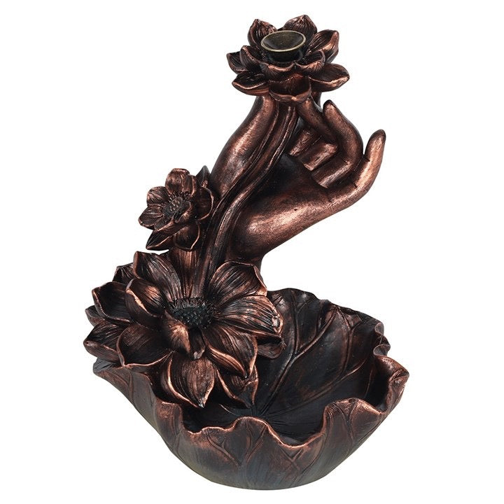 Bronze hand holding a lotus flower on a white background