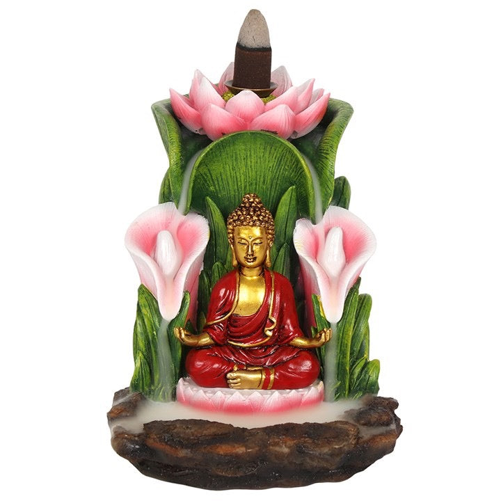 Decorative figurine of a Buddha sitting among pink flowers on a white background