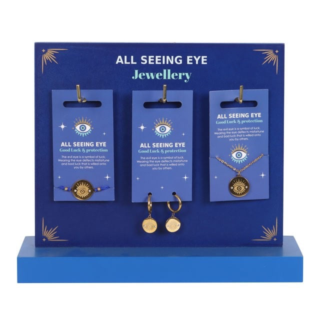 All Seeing Eye jewellery display with necklaces and earrings on blue stands.