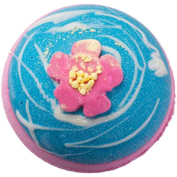 Blue and pink bath bomb with a flower design on a white background