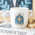 Mug with 'The Star' tarot card design on a book titled 'The Book of Tarot'.