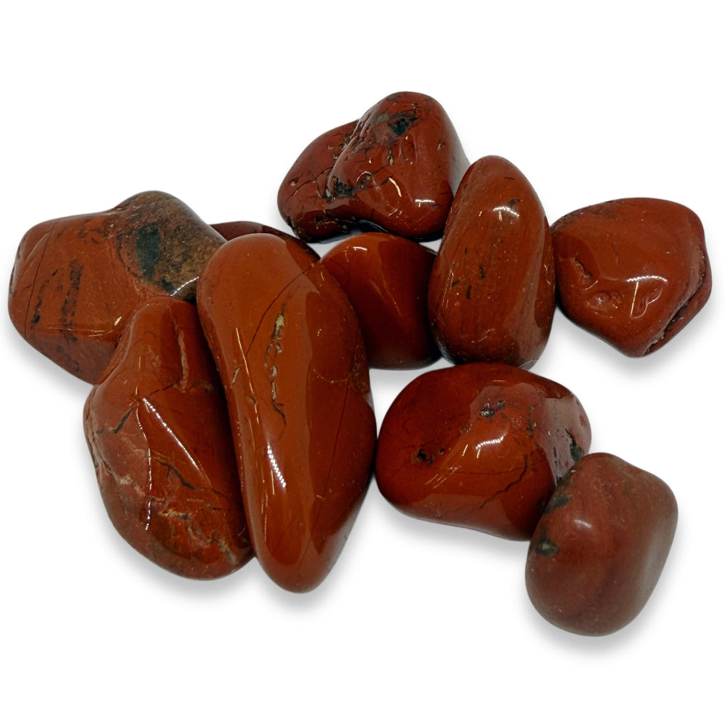 Collection of red jasper stones on a white background
