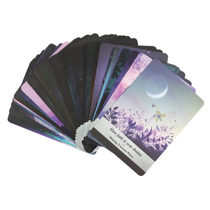 Set of tarot cards with a focus on one card showing a moon and nature design.