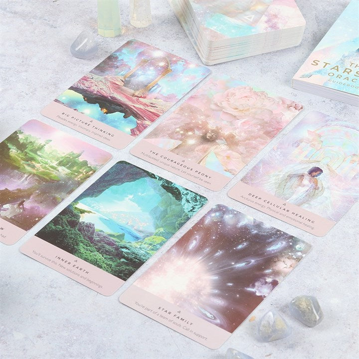 Set of tarot cards with pastel colors and nature-themed designs on a light surface.