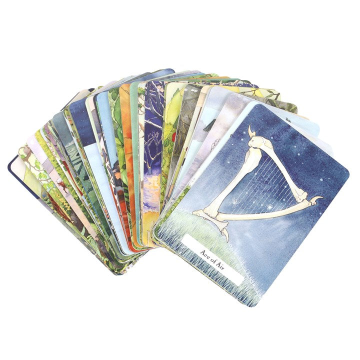 Collection of tarot cards with a prominent card featuring a harp on a white background