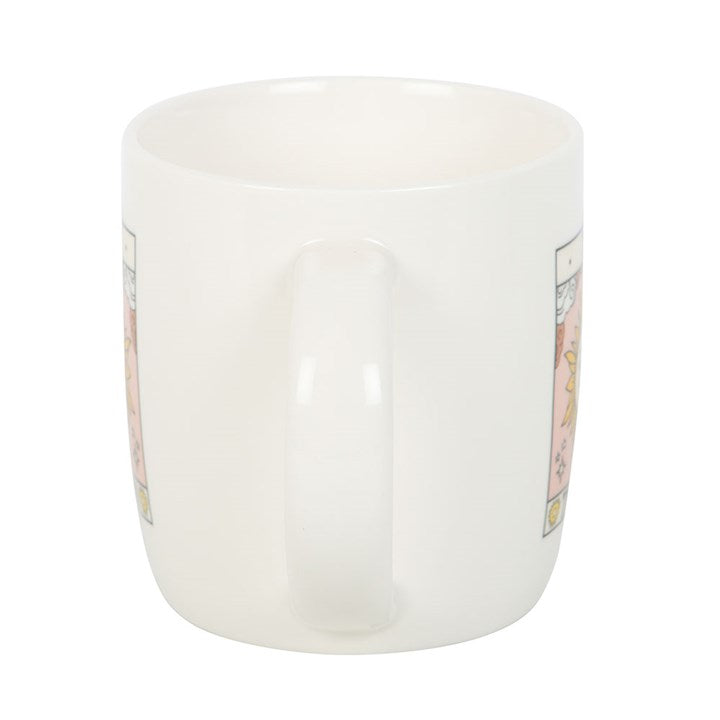 White mug with decorative labels on a white background
