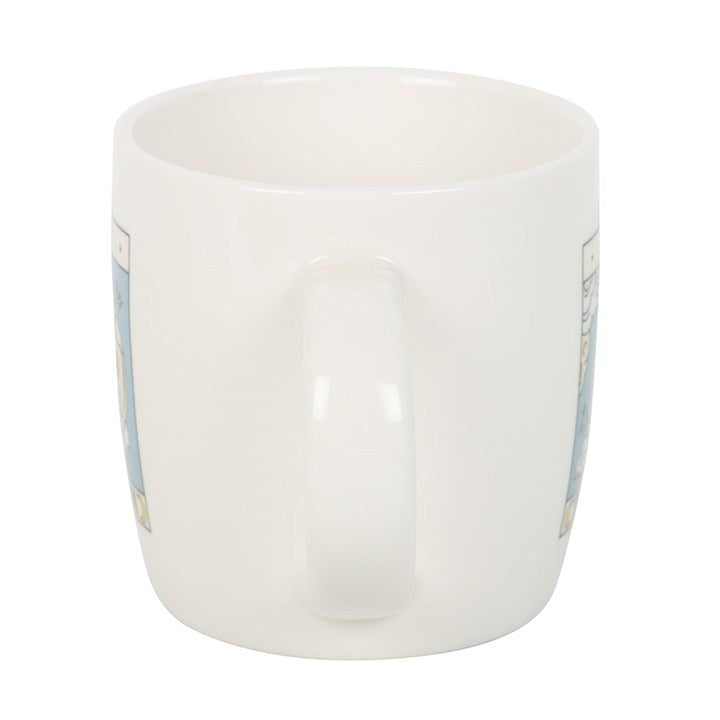 White ceramic mug with blue floral patterns on a white background