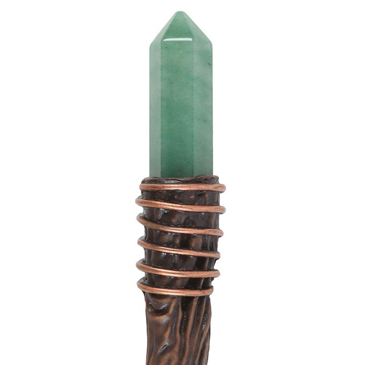 Green crystal wand with copper wrapping on a white background
