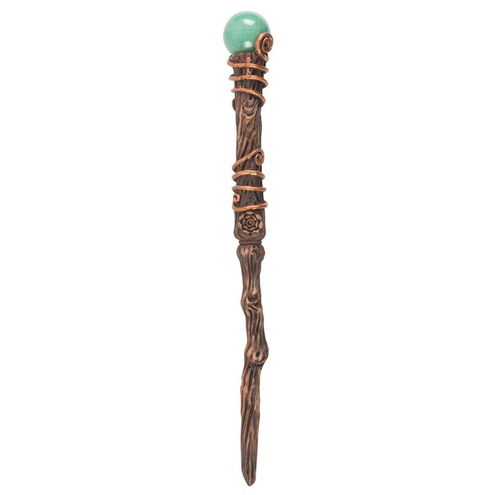 Decorative wand with a green gemstone on a white background