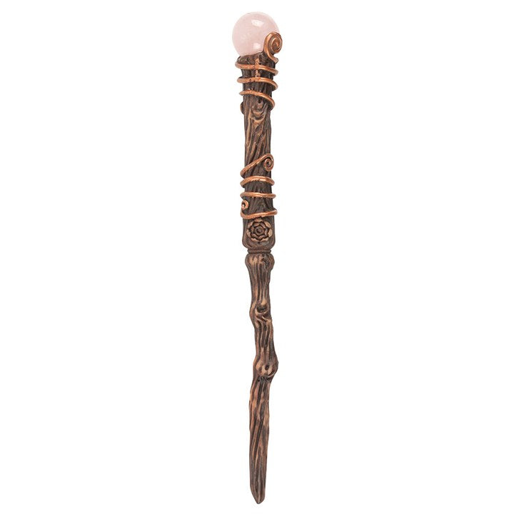 Decorative wand with a pink gem on a white background