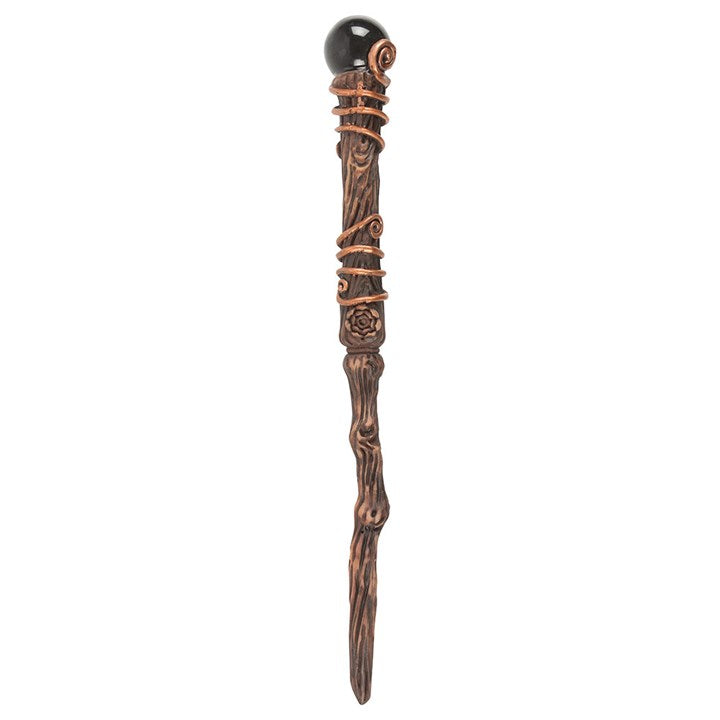 Decorative wand with a black top and bronze accents on a white background