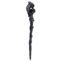 Decorative staff with dragon head and black sphere on a white background