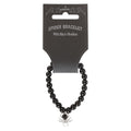 Black beaded bracelet with spider charm on a black card packaging.